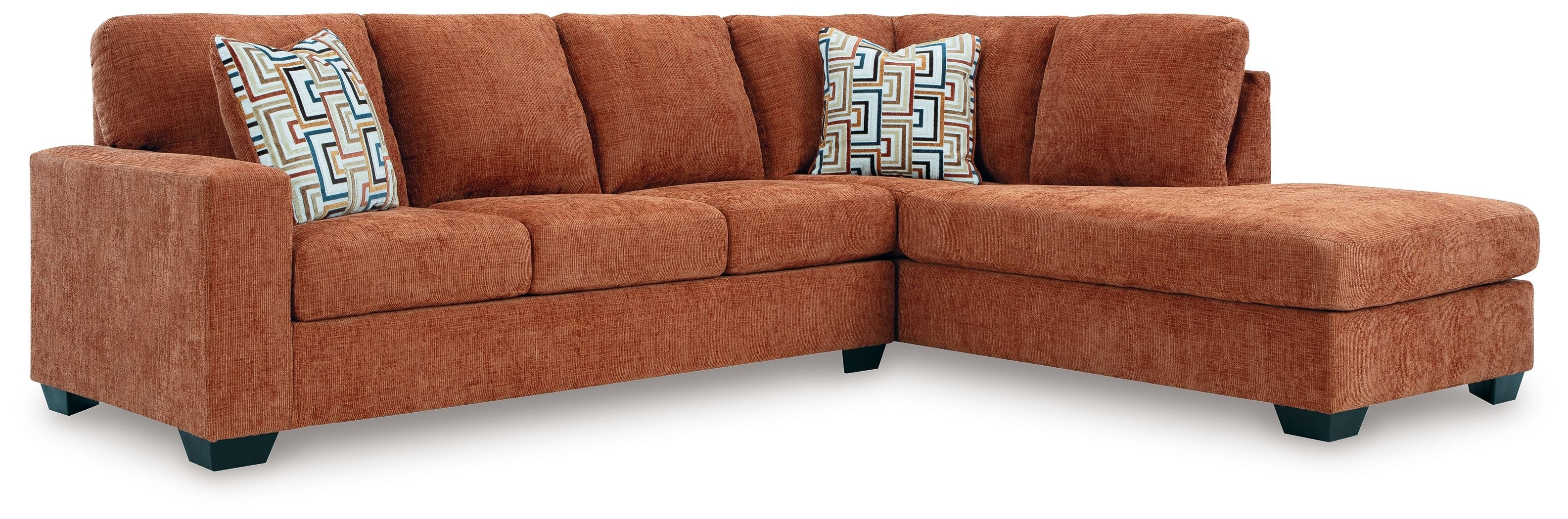 Spice rust sectional sofa with corner chaise and three geometric accent cushions