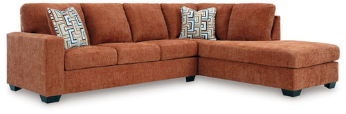Spice rust sectional sofa with corner chaise and three geometric accent cushions