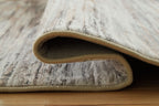 Nace rug rolled edge showing tan bound border and underside fabric