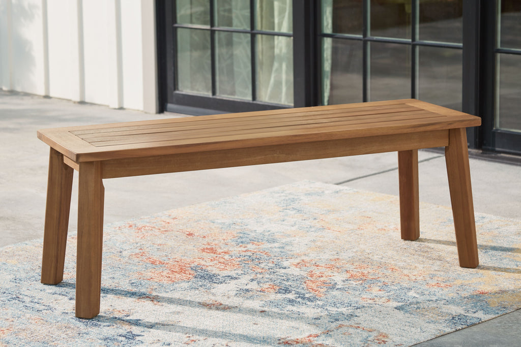 Light brown wooden bench with long slatted seat and tapered legs