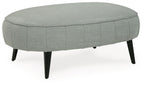Gray upholstered ottoman with stitched skirt and tapered legs