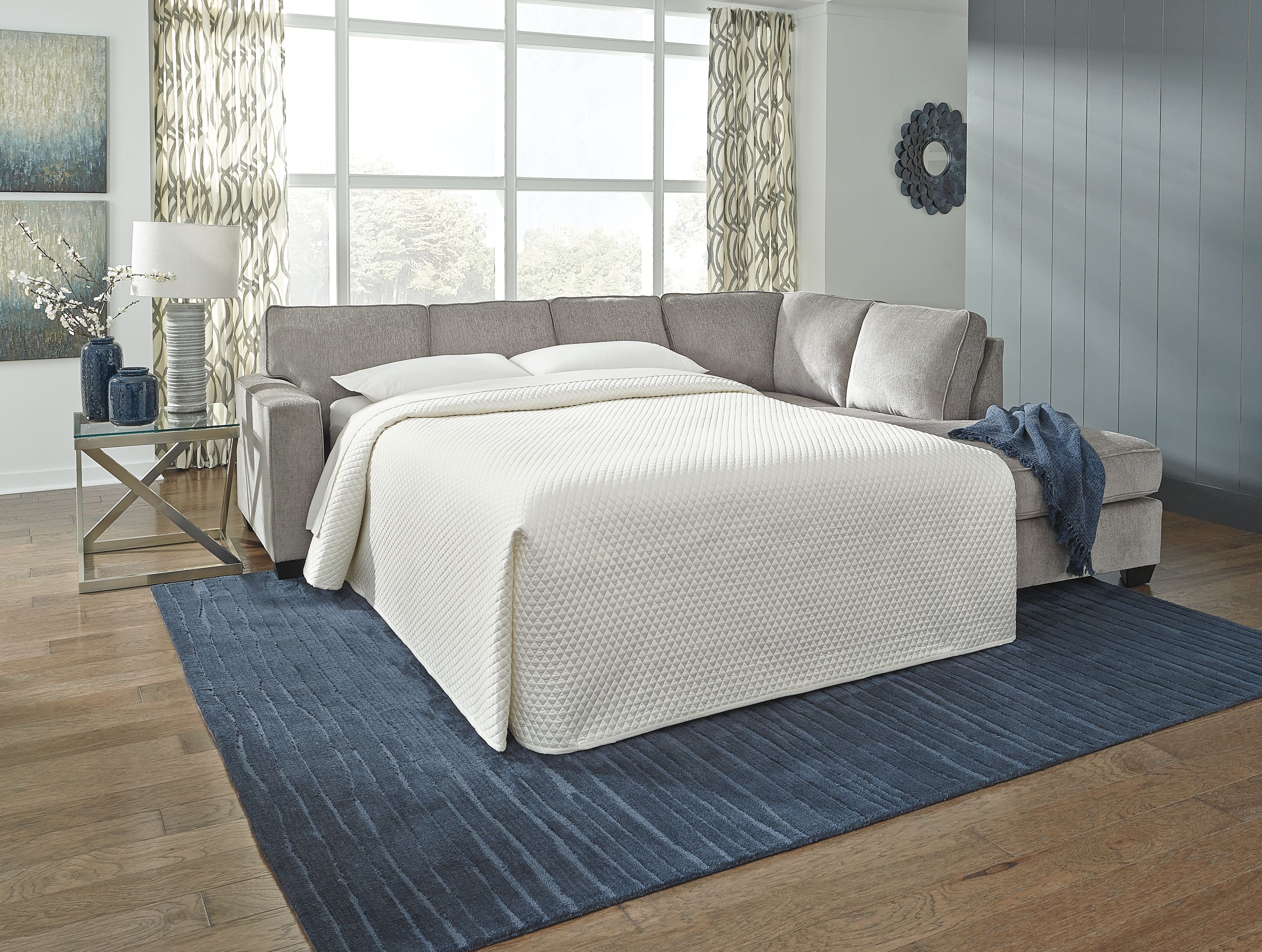 Sofa sleeper with open bed, gray upholstery and white mattress