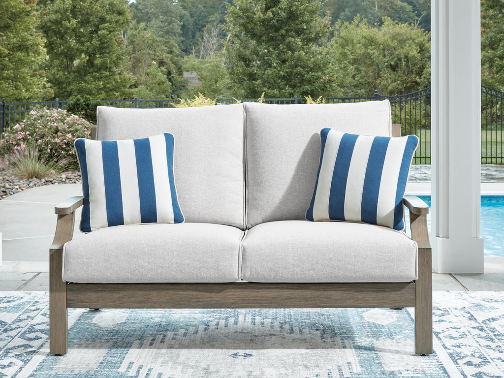 Loveseat with cushion, light gray fabric and two blue-striped pillows
