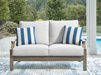 Loveseat with cushion, light gray fabric and two blue-striped pillows
