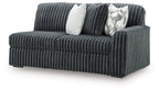 Gunmetal ribbed sofa with square armrest and two decorative pillows