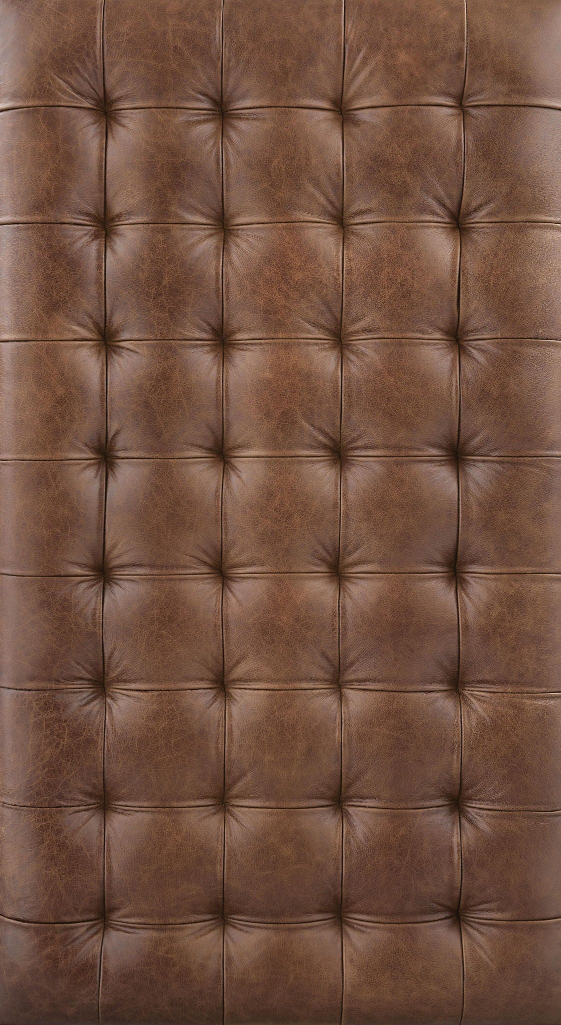 Brown leather-look tufted upholstery with diamond stitching