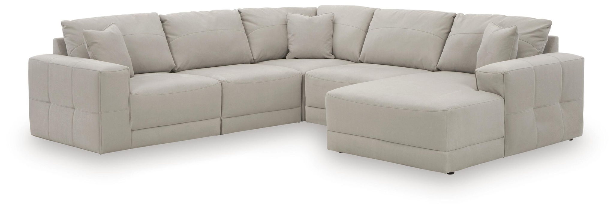 Light gray sectional sofa with chaise, L-shaped arrangement and tufted back cushions