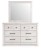 White dresser with large attached mirror and multi-drawer storage with dark pulls
