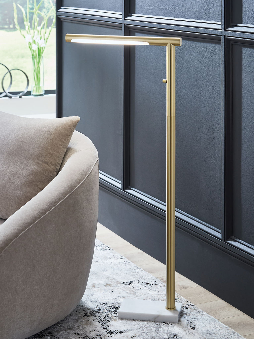 Santiford gold metal floor lamp with tall slender pole and square base