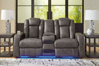 Dark gray power reclining loveseat with padded headrests and center console controls