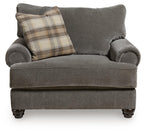 Gray chair-and-a-half with rolled arms and plaid lumbar pillow on the seat