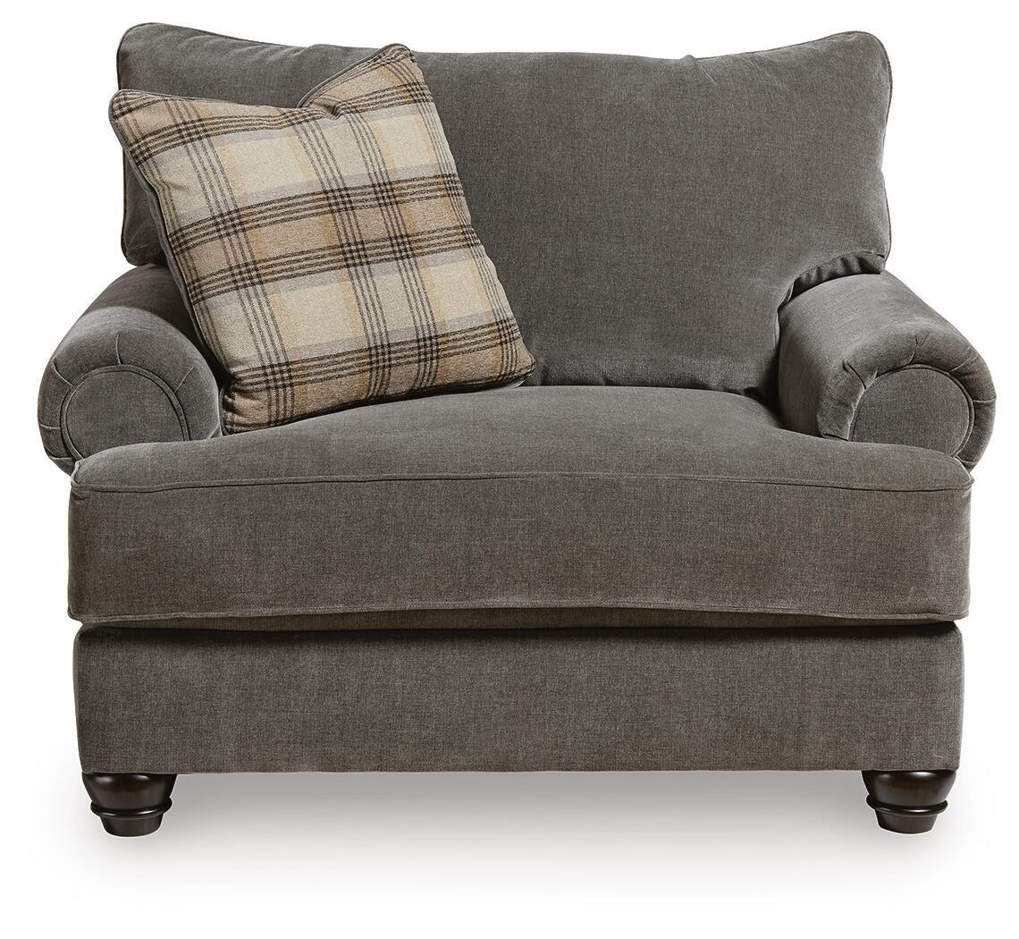 Gray chair-and-a-half with rolled arms and plaid lumbar pillow on the seat