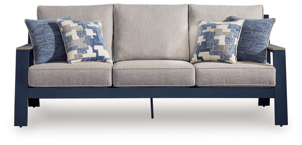 Outdoor sofa with light gray seat cushions and two blue patterned back pillows