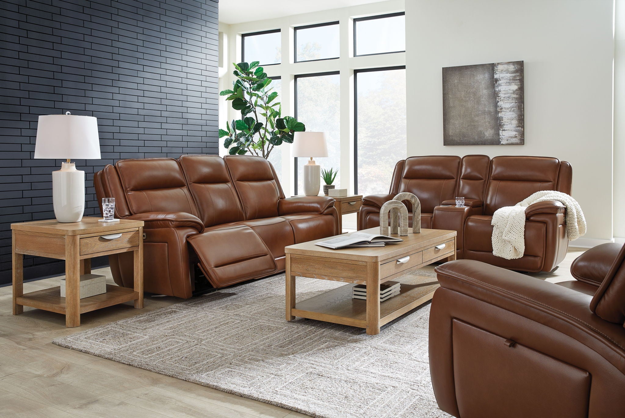 Dark brown leather power reclining sofa set with reclined seat backs and padded headrests