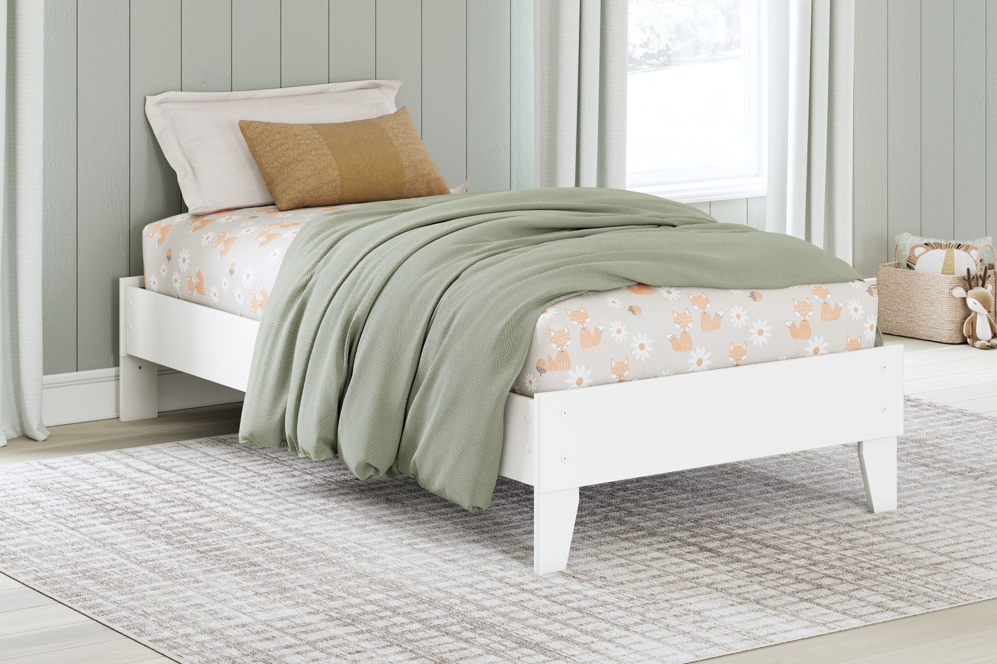 White platform bed with upholstered headboard, decorative pillows, and draped quilt