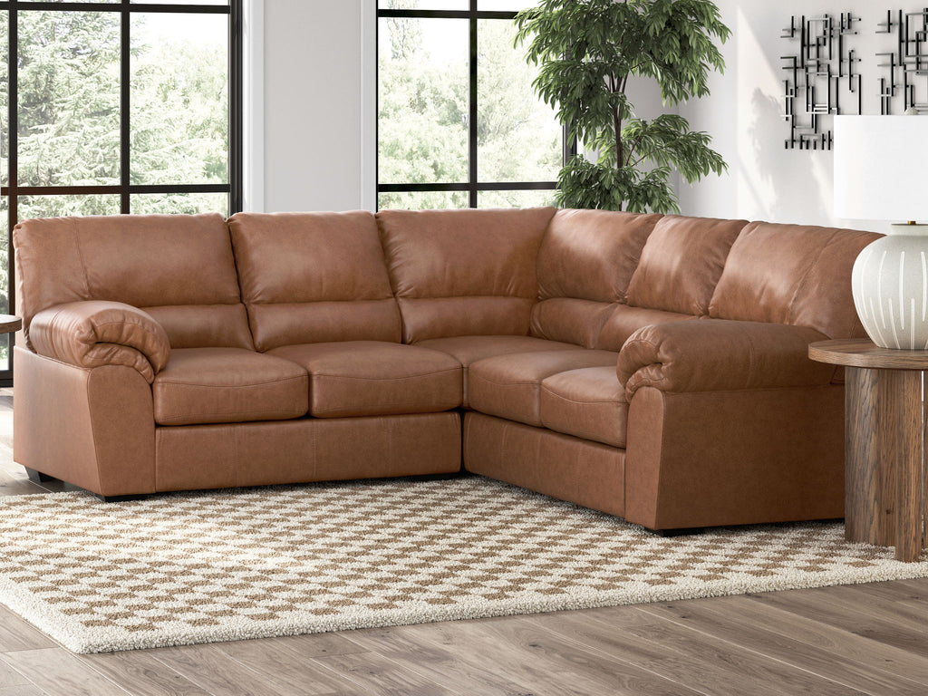 Brown sectional sofa with tufted back and chaise seating