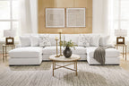 Light beige sectional sofa with chaise seating and patterned throw pillows