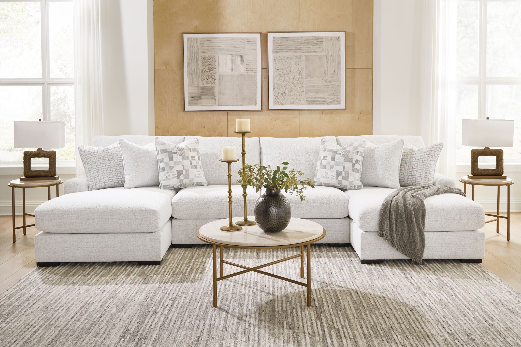 Light beige sectional sofa with chaise seating and patterned throw pillows