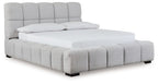 Gray upholstered bed with tufted headboard and padded side rails