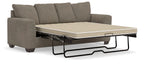 Gray queen sofa sleeper showing pull-out bed frame and beige mattress panel