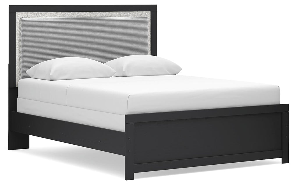 Black upholstered panel bed frame with white bedding and curved pillows