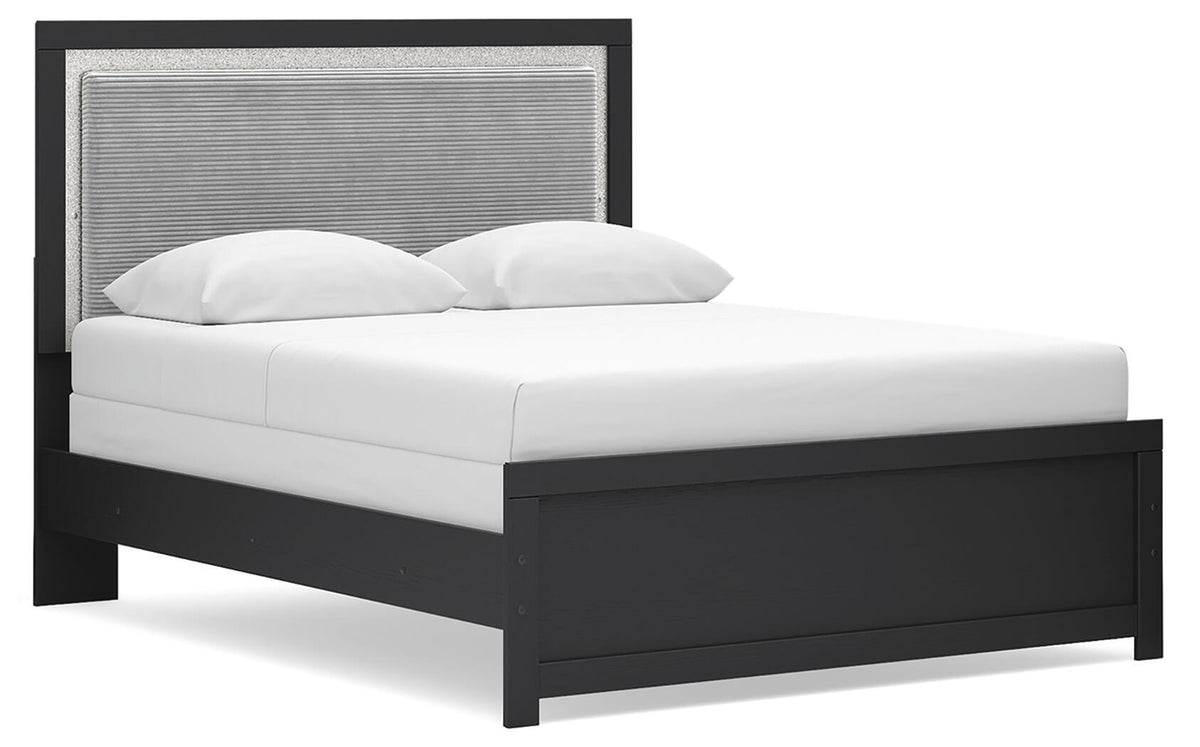 Black upholstered panel bed frame with white bedding and curved pillows