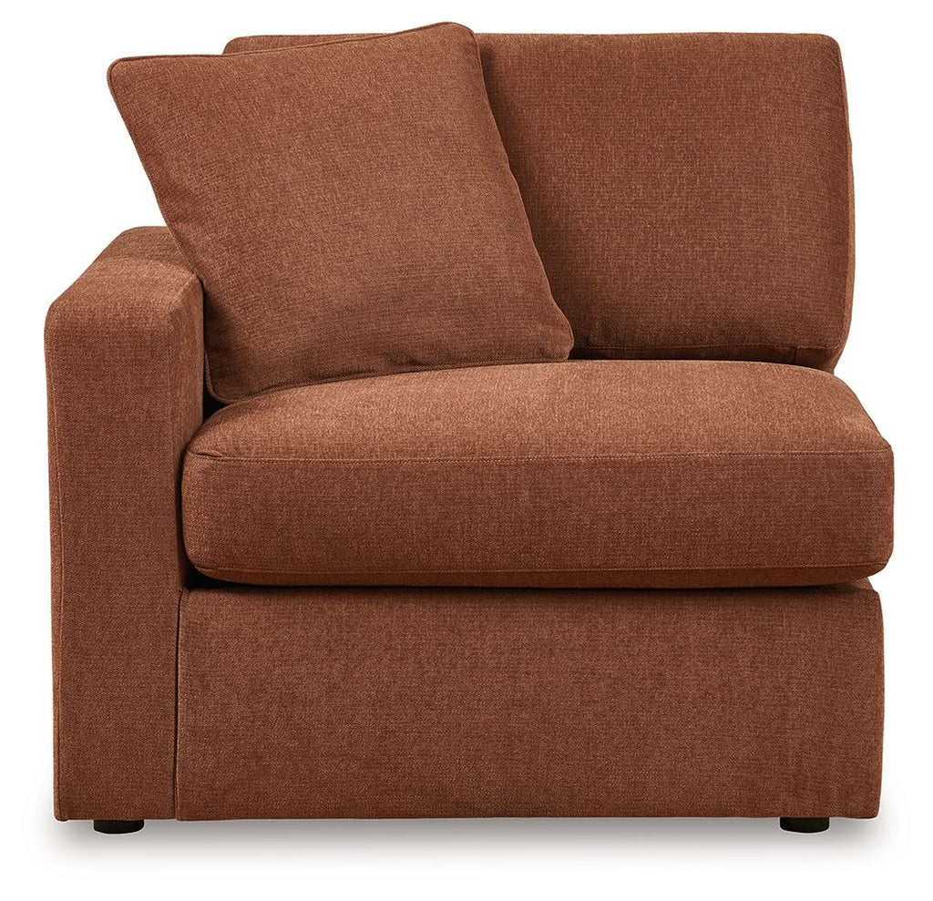 Brown upholstered corner chair with two large back pillows and padded seat
