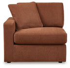 Brown upholstered corner chair with two large back pillows and padded seat