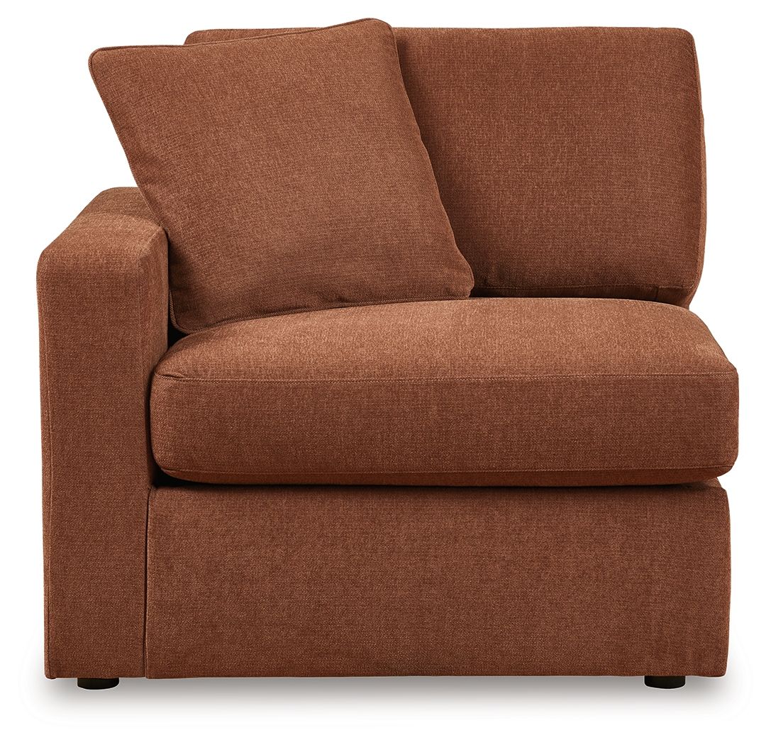 Brown upholstered corner chair with two large back pillows and padded seat