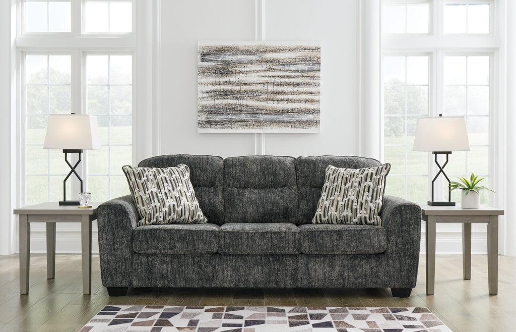 Lonoke sofa in dark gray upholstery with patterned accent pillows