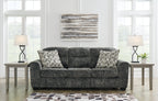 Lonoke sofa in dark gray upholstery with patterned accent pillows