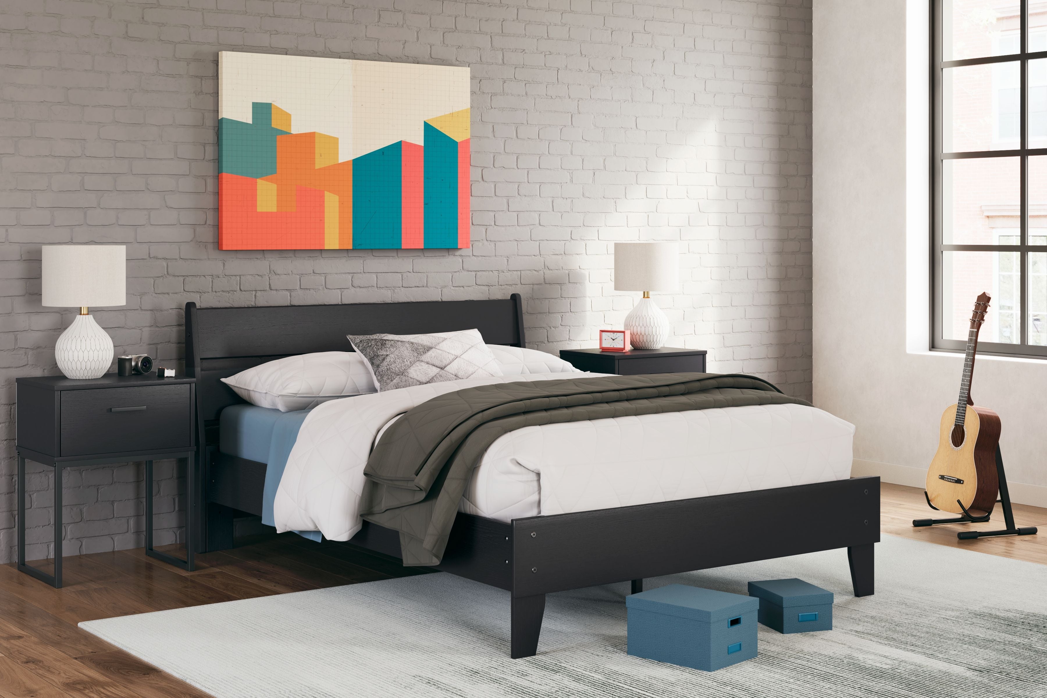 Black panel platform bed with white pillows and dark green throw blanket