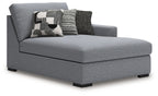Gray RAF corner chaise with wide seat cushion, tall back, and patterned throw pillows