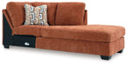 Spice orange-brown corner chaise with upholstered arms and patterned accent pillow