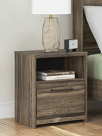 Brown one-drawer night stand with open shelf and drawer; top surface with lamp and books