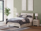 Light wood panel bed with storage drawers, gray bedding with headboard detail