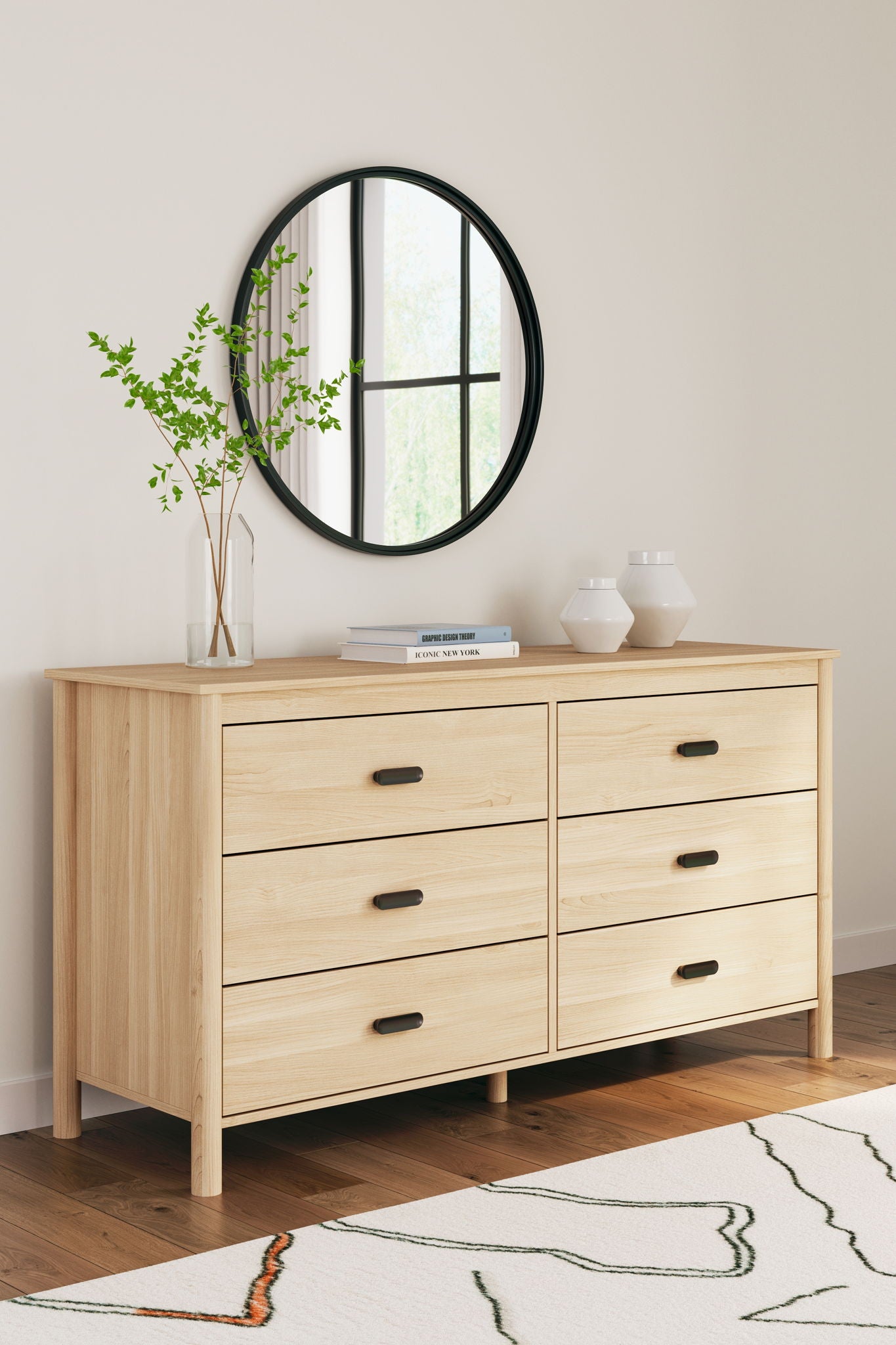 Wood dresser with black round mirror and six drawers, light beige finish