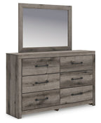 Gray-brown wooden dresser with rectangular mirror and six drawers, black knob pulls