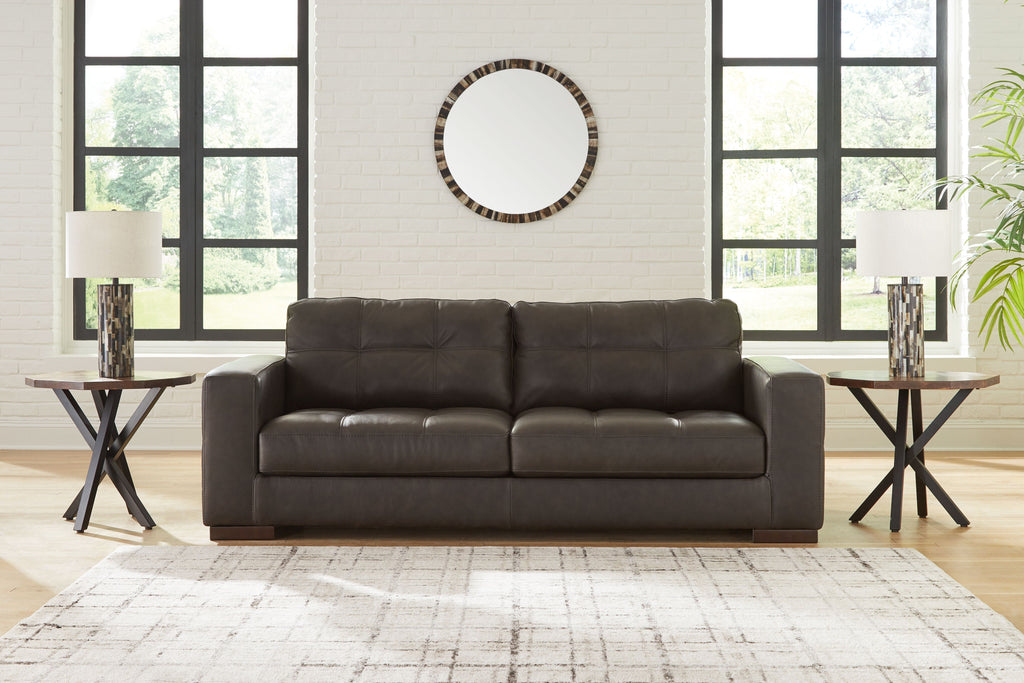 Dark brown tufted sofa with three seat cushions and padded backrest