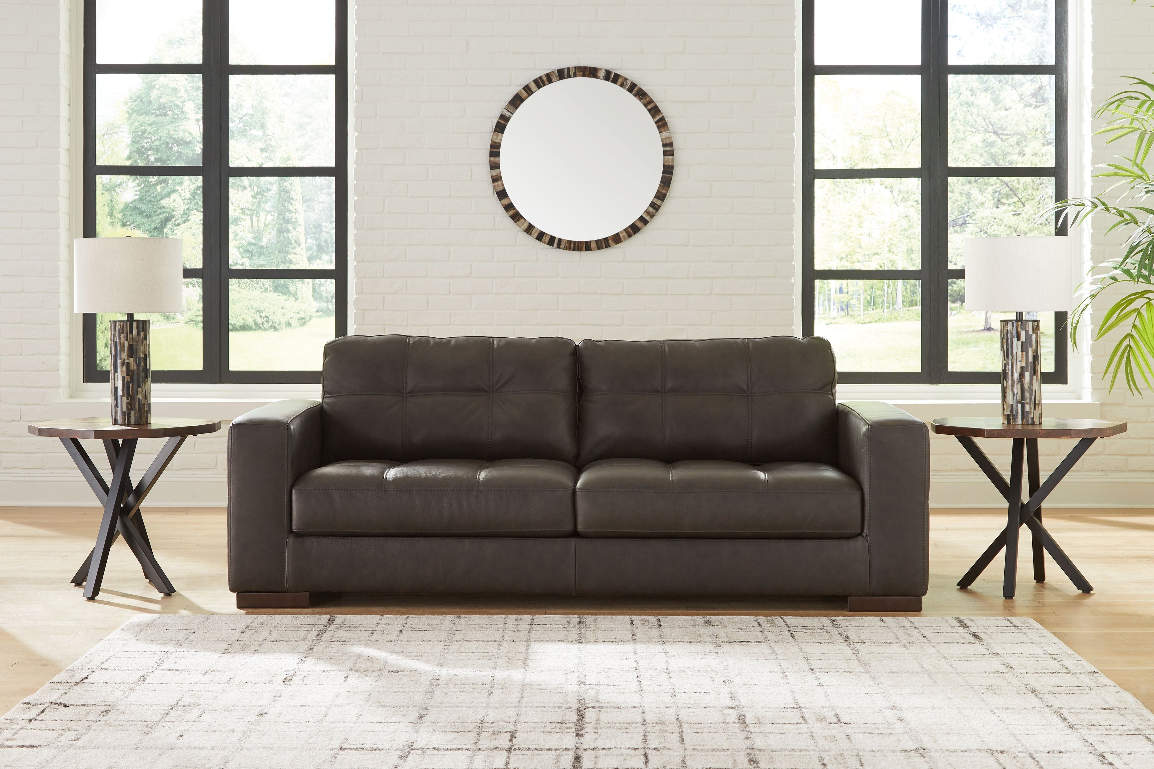 Dark brown tufted sofa with three seat cushions and padded backrest