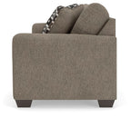 Beige fabric sofa end with armrest and check-pattern throw pillow
