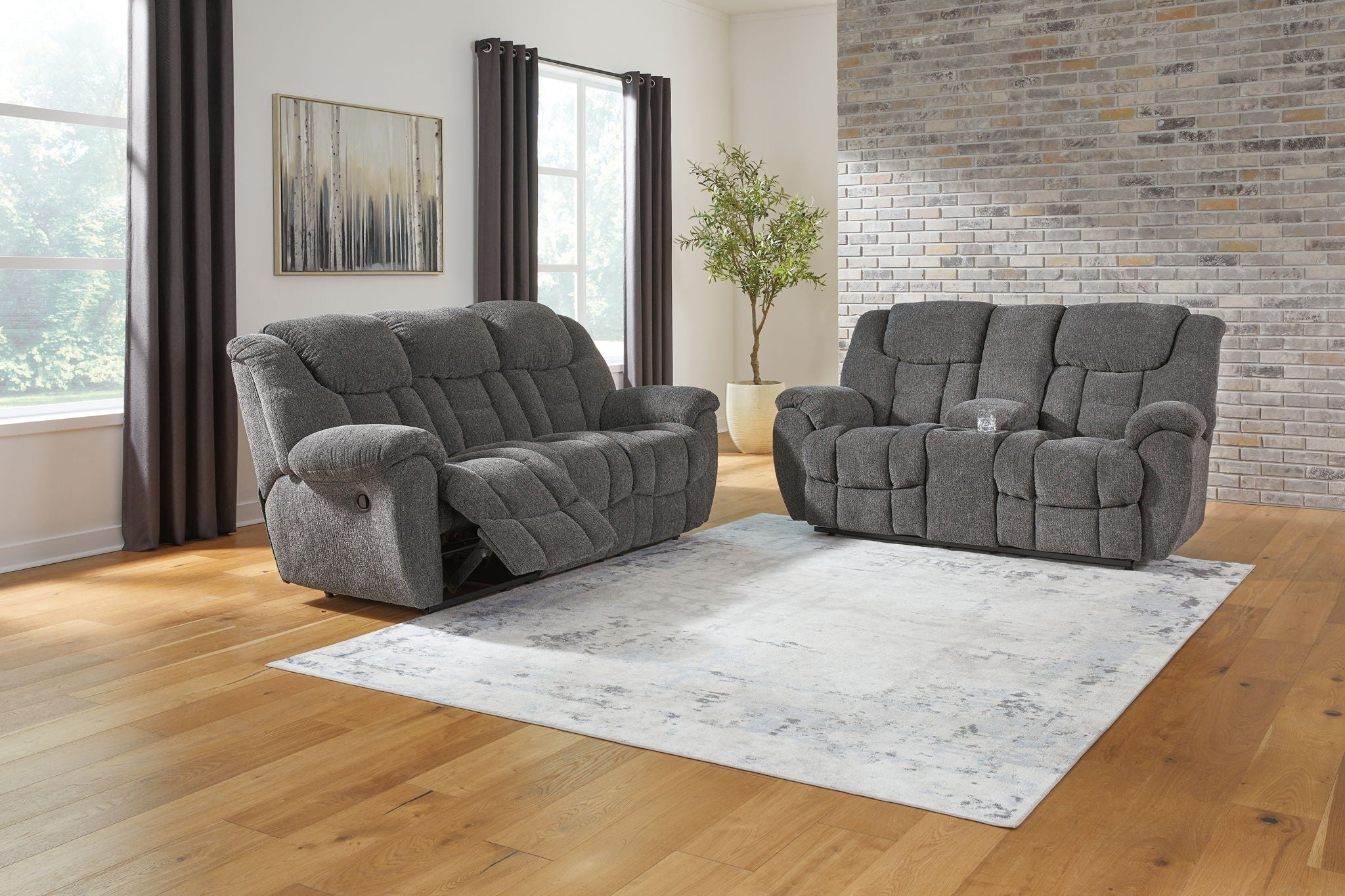 Dark gray reclining seating set with tufted upholstery: sofa and loveseat
