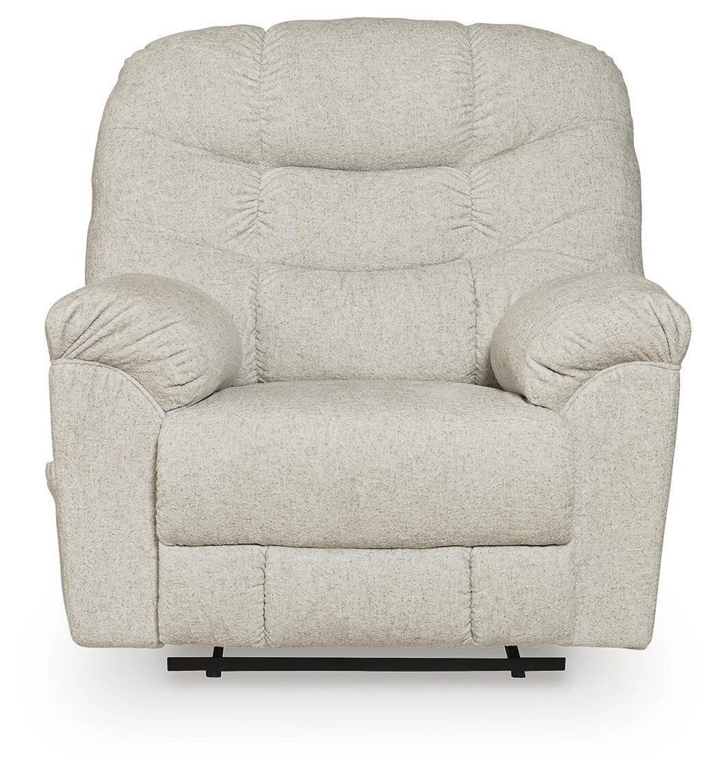 Light beige upholstered recliner with rounded arms, tufted back cushions, and centered seat
