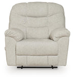 Light beige upholstered recliner with rounded arms, tufted back cushions, and centered seat