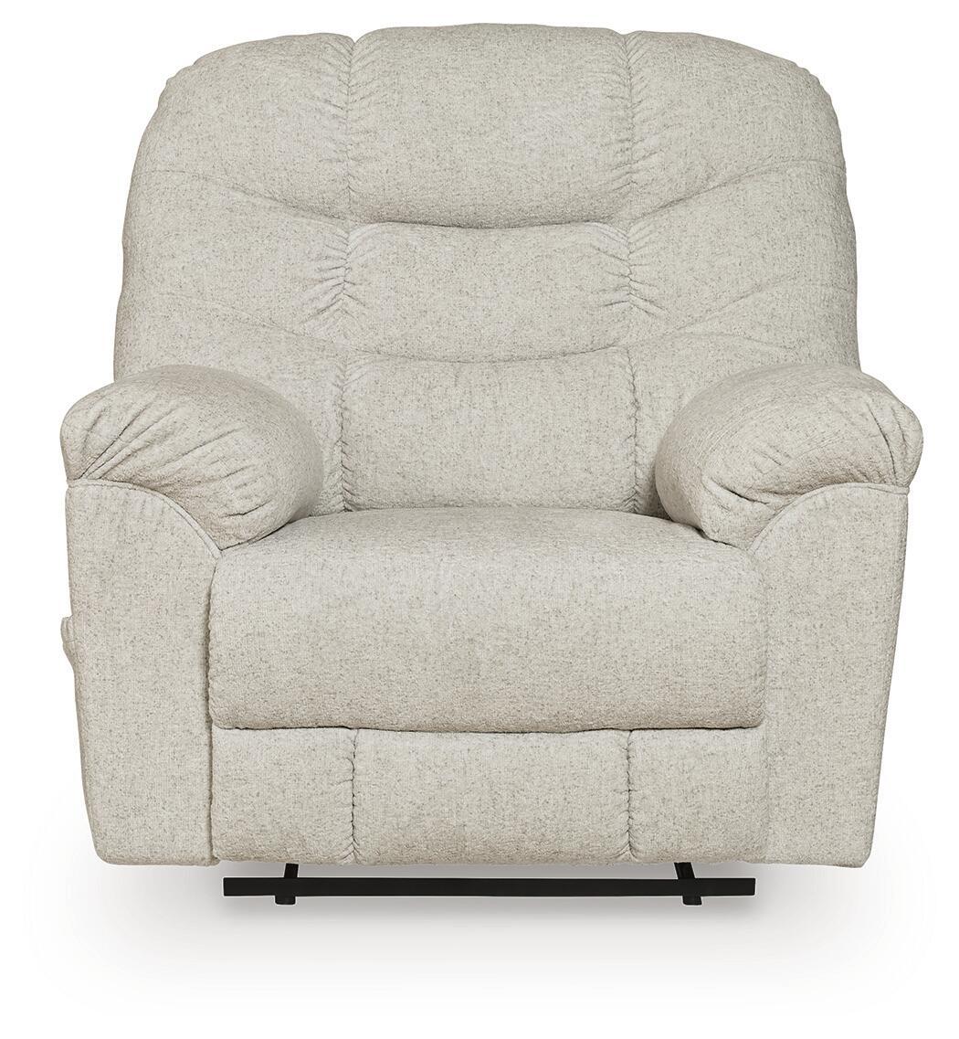 Light beige upholstered recliner with rounded arms, tufted back cushions, and centered seat