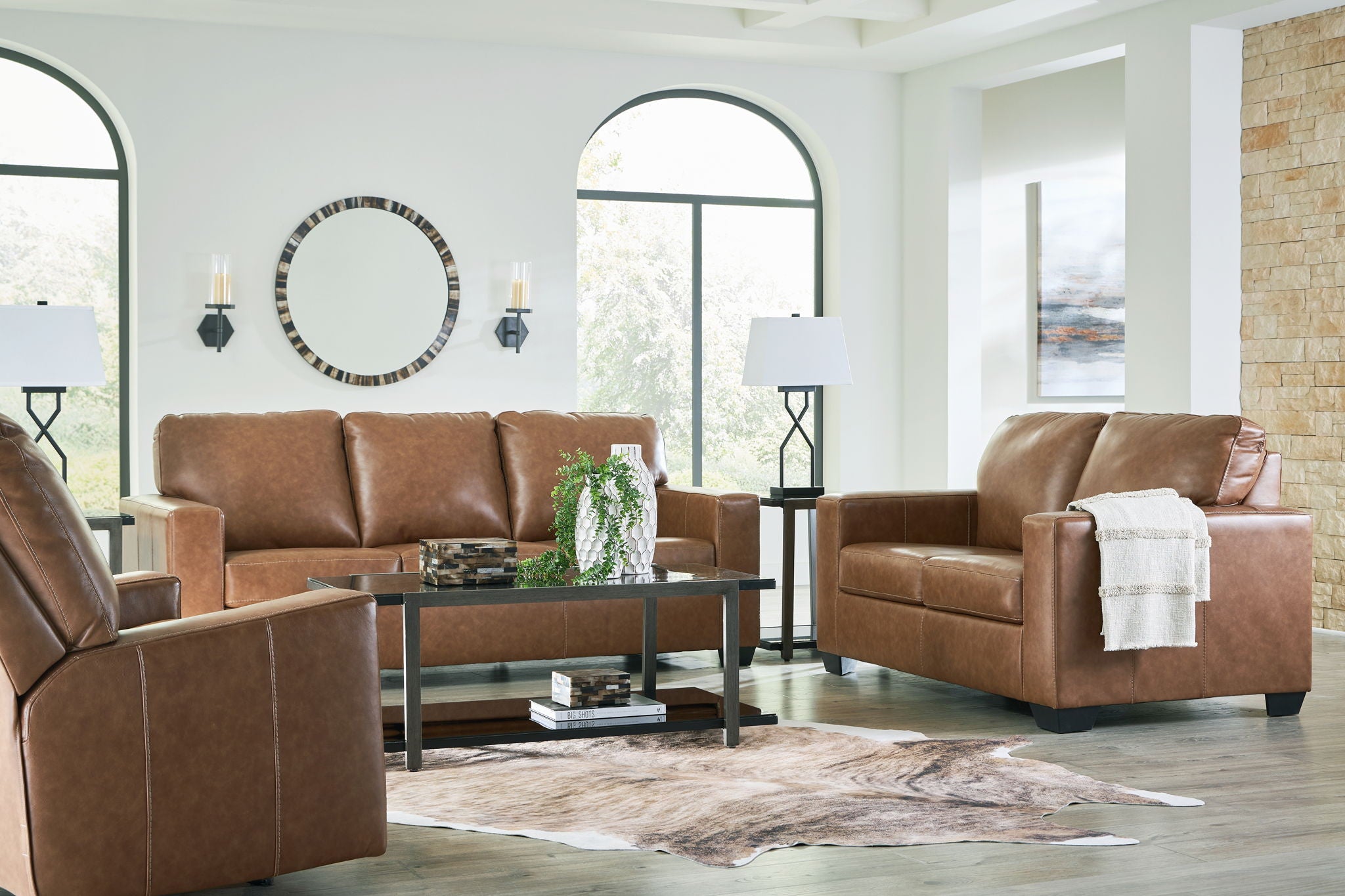 Brown leather sofa and matching armchair with padded seats and square arms
