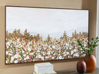 Framed wall art with multicolor foliage and white blossoms under a pale sky
