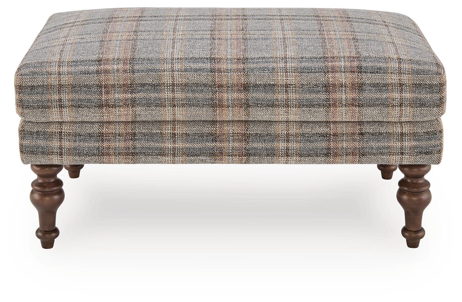 Multi plaid ottoman with smooth upholstered top and dark wooden turned legs