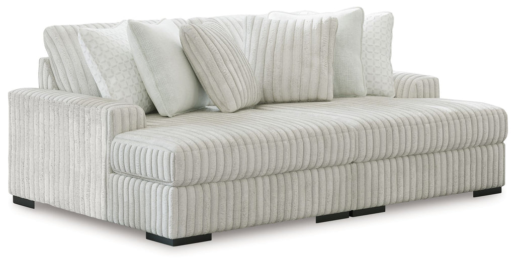 Sectional sofa with chaise, light-colored striped upholstery and three back cushions