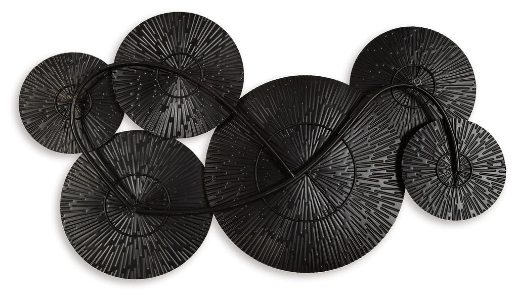 Black and gold wall decor featuring overlapping round metal disc set with radial fans
